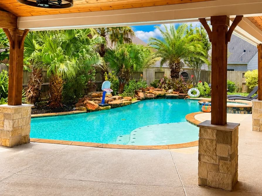 Covered patio freeform pool waterfall