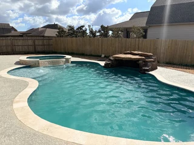 Freeform pool spa rock grotto waterfall